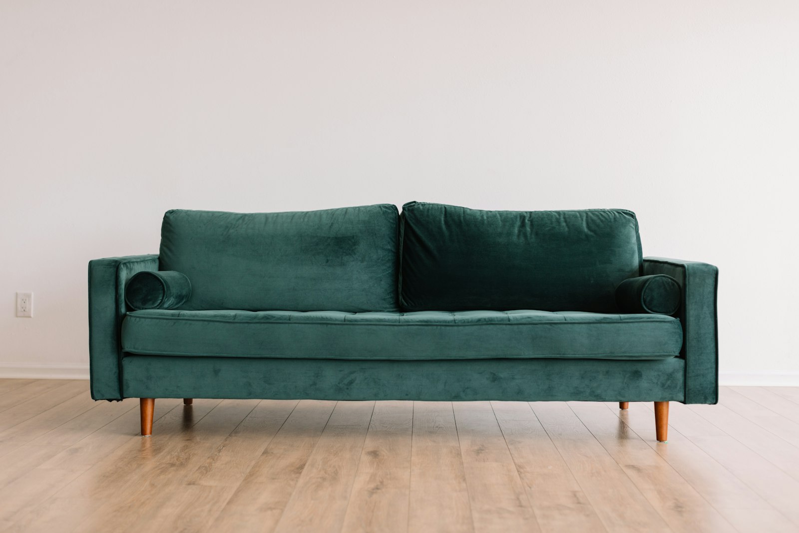 Green velvet sofa in a bright room